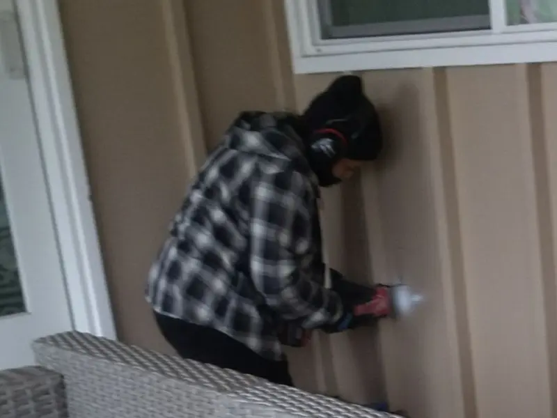 Professional electrician installing an exterior outlet in Traverse City